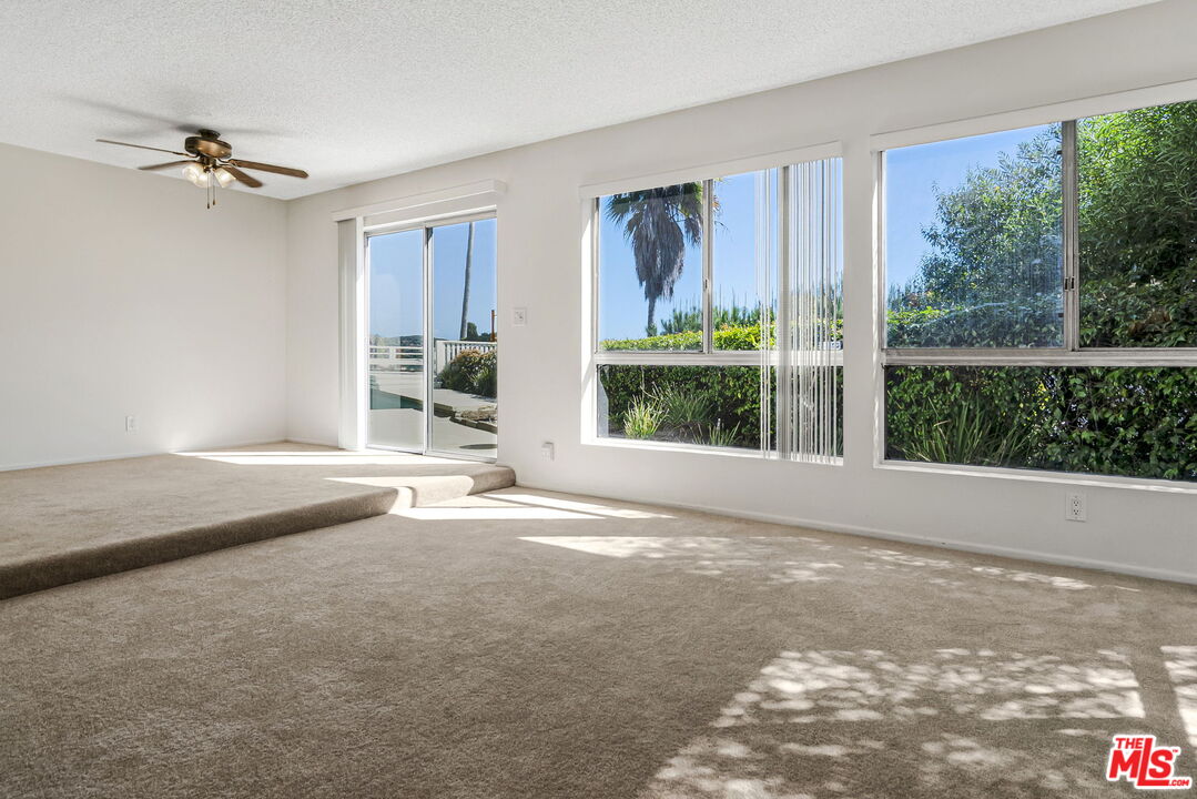 2695 Cordelia Road Los Angeles, CA 90049 - Photo 6 of 33 a view of a livingroom with a floor to ceiling window and a kitchen