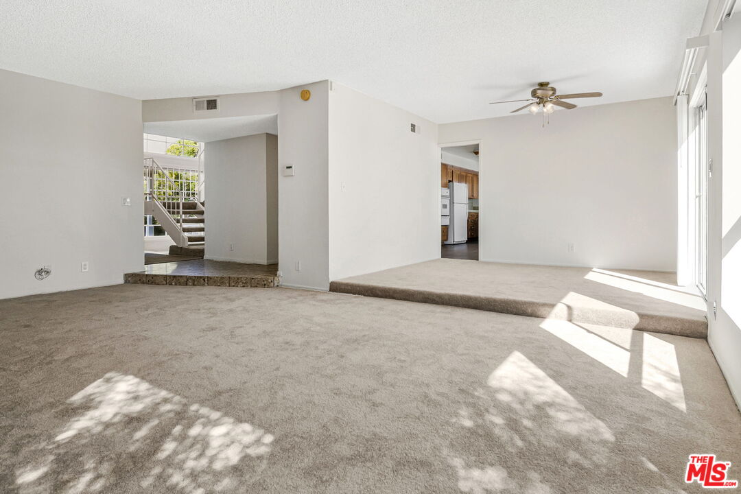 2695 Cordelia Road Los Angeles, CA 90049 - Photo 7 of 33 a view of a livingroom with wooden floor and a ceiling fan