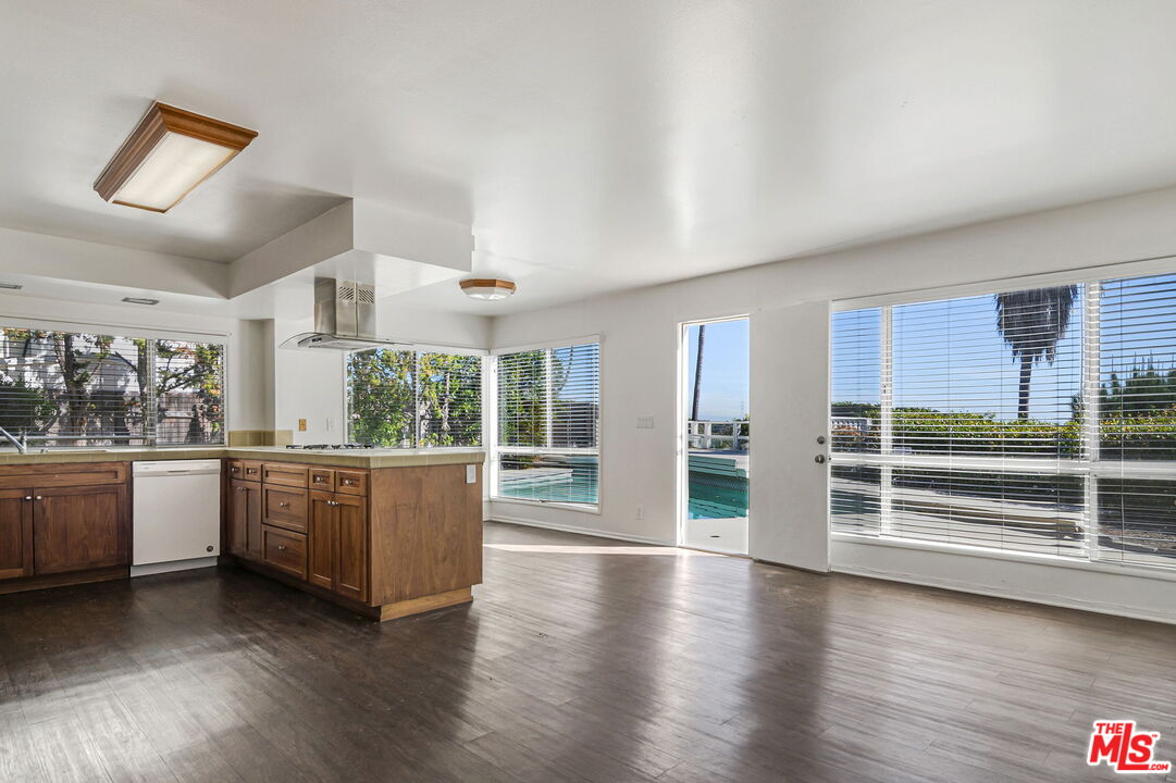 2695 Cordelia Road Los Angeles, CA 90049 - Photo 10 of 33 a kitchen with stainless steel appliances granite countertop a stove and cabinets