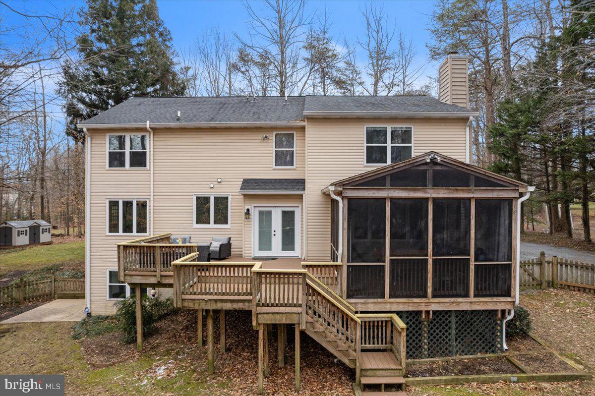 650 Small Reward Road Huntingtown, MD 20639 - Photo 4 of 21 a view of a house with a wooden deck and a chair