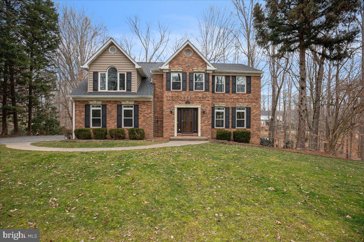 650 Small Reward Road Huntingtown, MD 20639 - Photo 5 of 21 a front view of a house with a garden