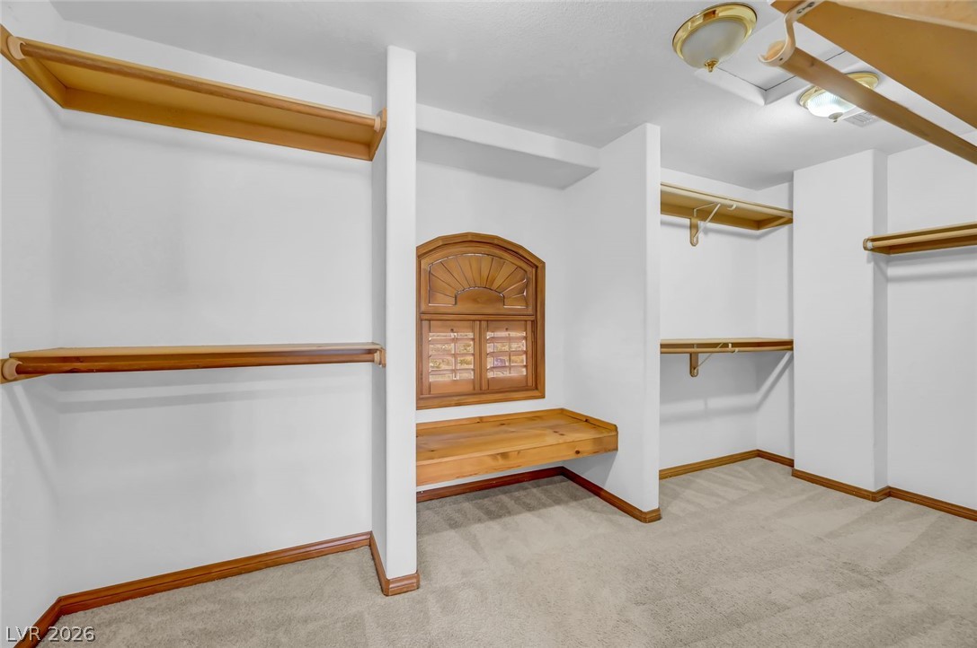 640 North Racetrack Road Henderson, NV 89015 - Photo 46 of 65 Ample storage solutions abound in this well-appointed closet, featuring built-in shelving and a window seat.