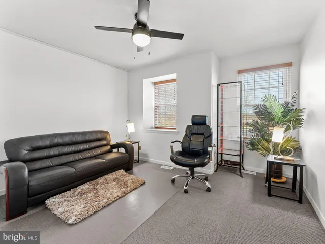 a livingroom with workspace and a couch