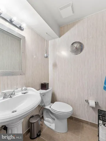 a bathroom with a white toilet sitting next to a bathroom sink