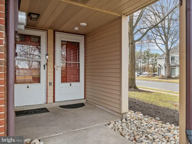 a view of a door of a house with a street