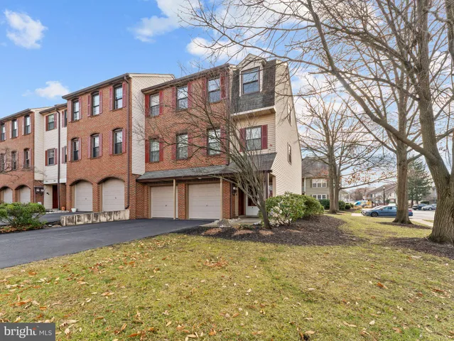 a front view of a building with a garden