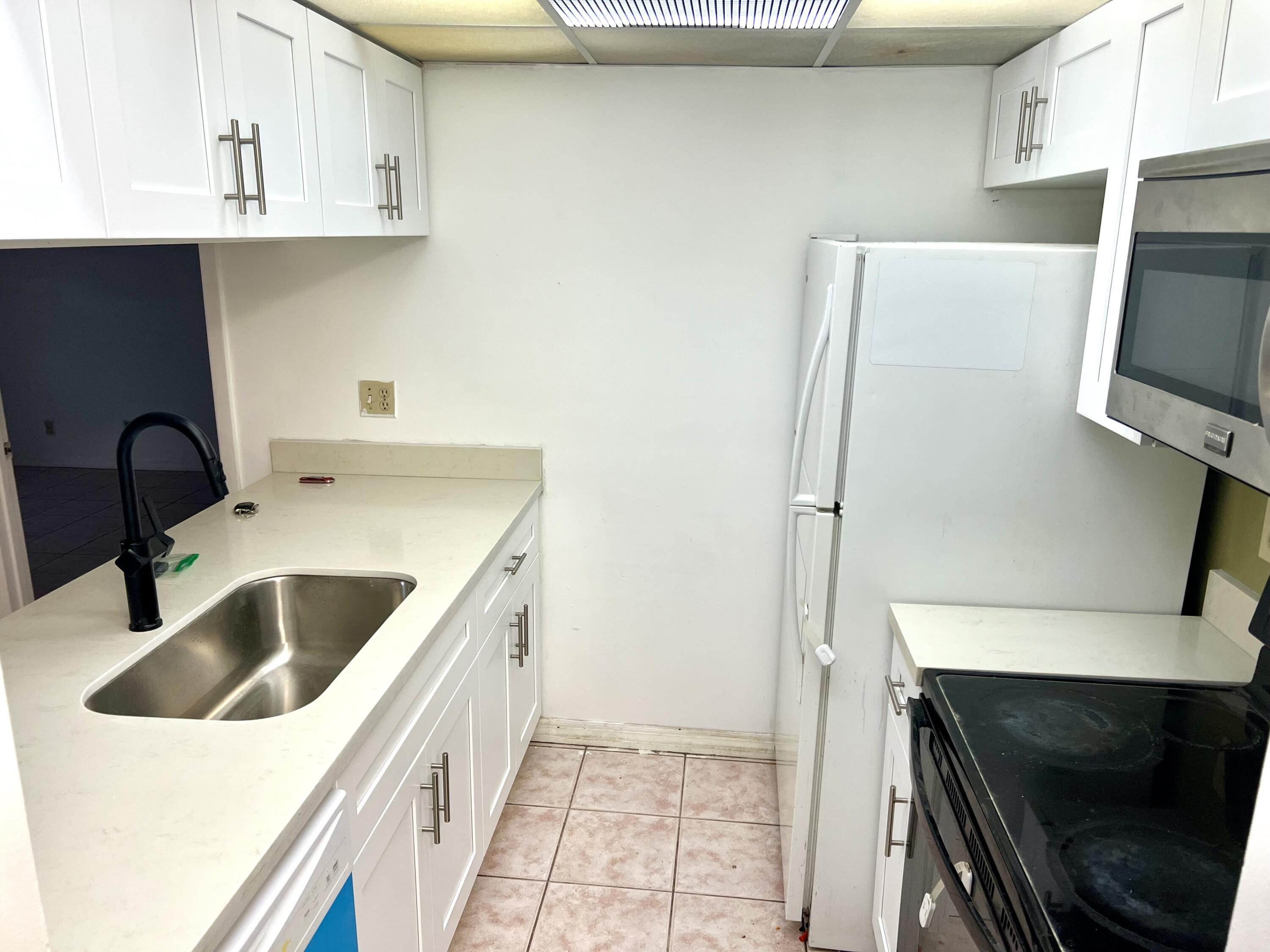 a kitchen with a sink and a refrigerator