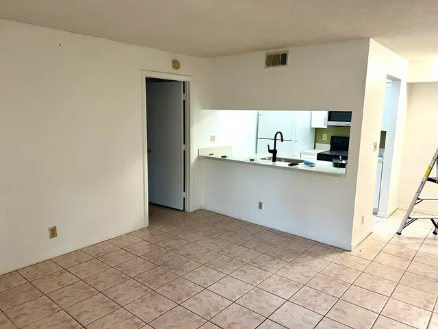 a kitchen with granite countertop a sink and cabinets