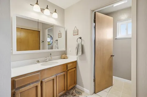 a bathroom with a sink vanity and mirror