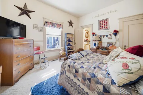 a bedroom with a bed and flat screen tv