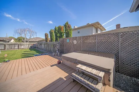 a view of a roof deck with wooden floor and fence
