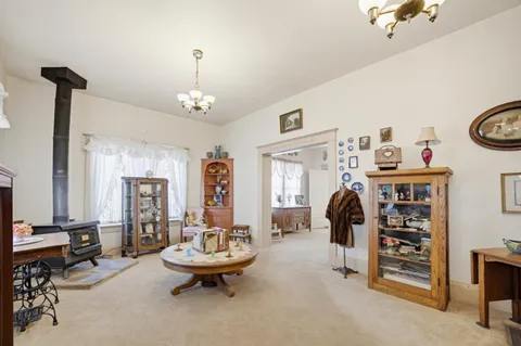 a living room with furniture and a chandelier