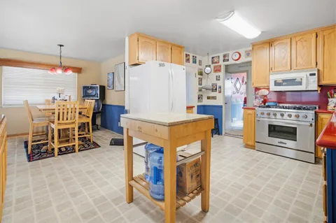 a living room with furniture a fireplace and a table