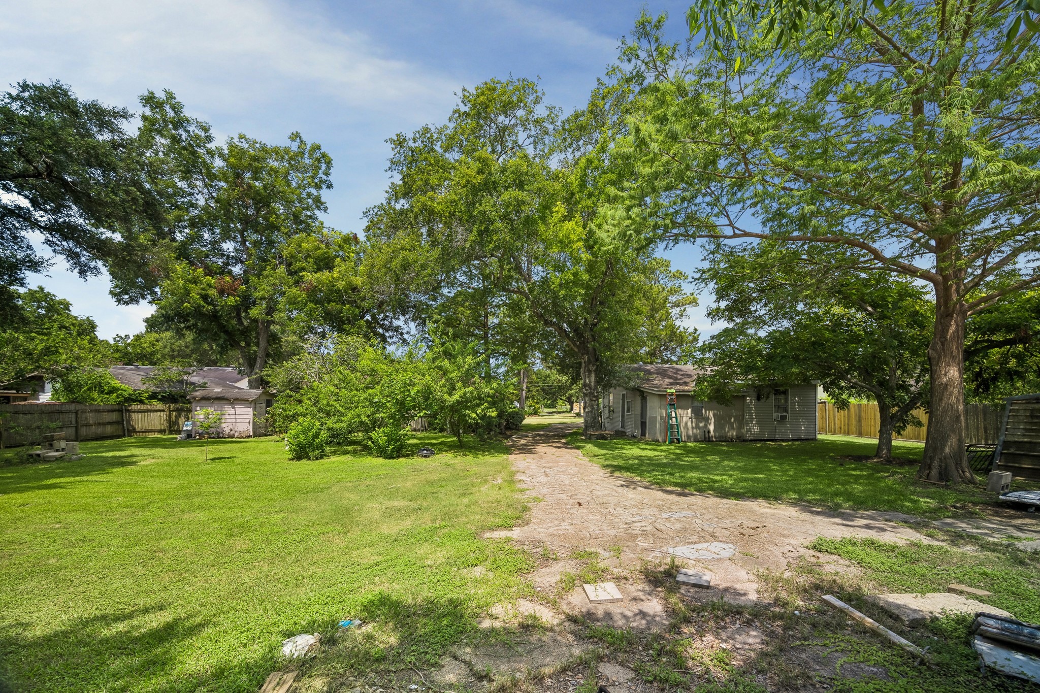 413 Mebane Lane Rosenberg, TX 77471 - Photo 28 of 30 This spacious backyard with mature trees is waiting for your personal creativity.