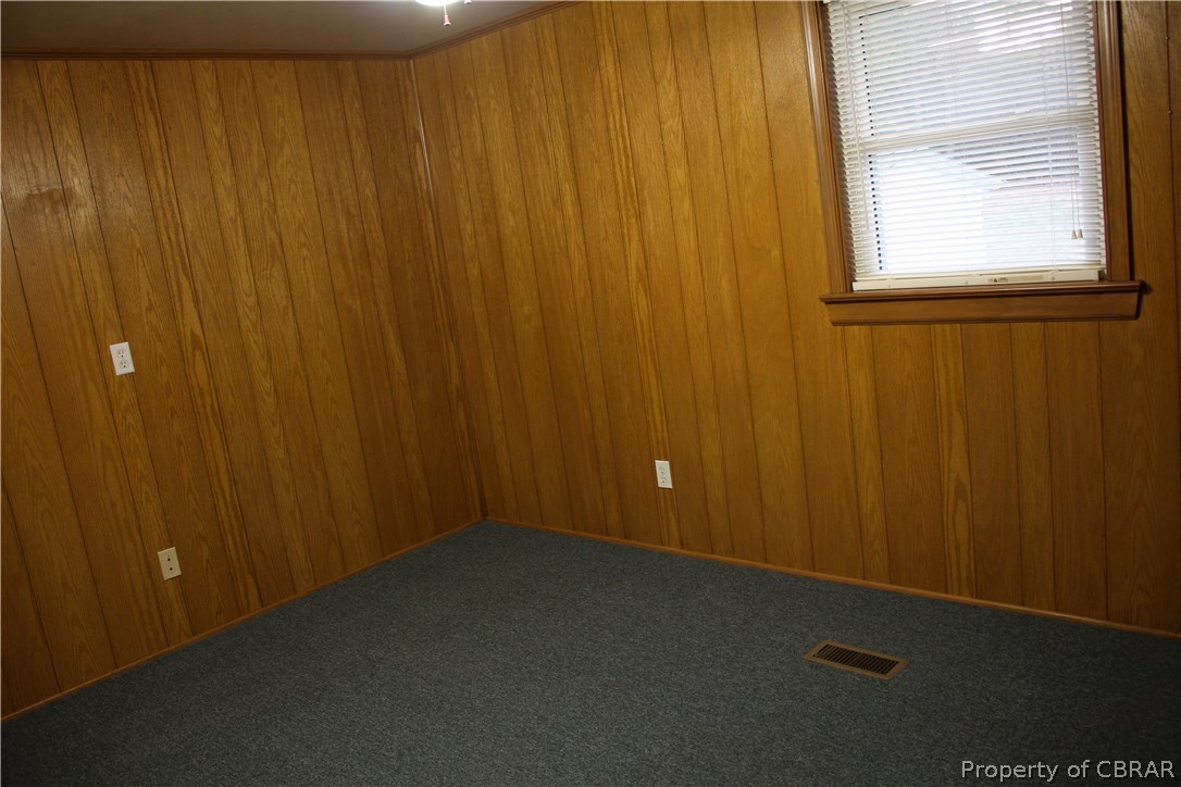 1174 North River Road Bohannon, VA 23021 - Photo 26 of 35 an empty room with a wooden door