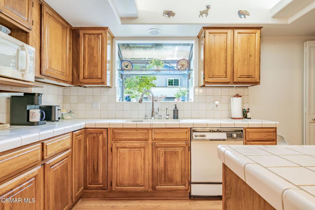 6078 Peppertree Lane Simi Valley, CA 93063 - Photo 17 of 59 a kitchen with stainless steel appliances granite countertop a sink and cabinets