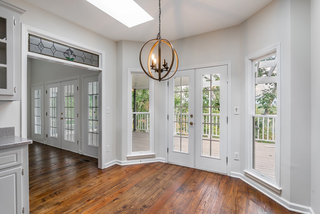 1265 Hunters Ridge Jasper, GA 30143 - Photo 12 of 50 a view of an empty room with wooden floor and a window