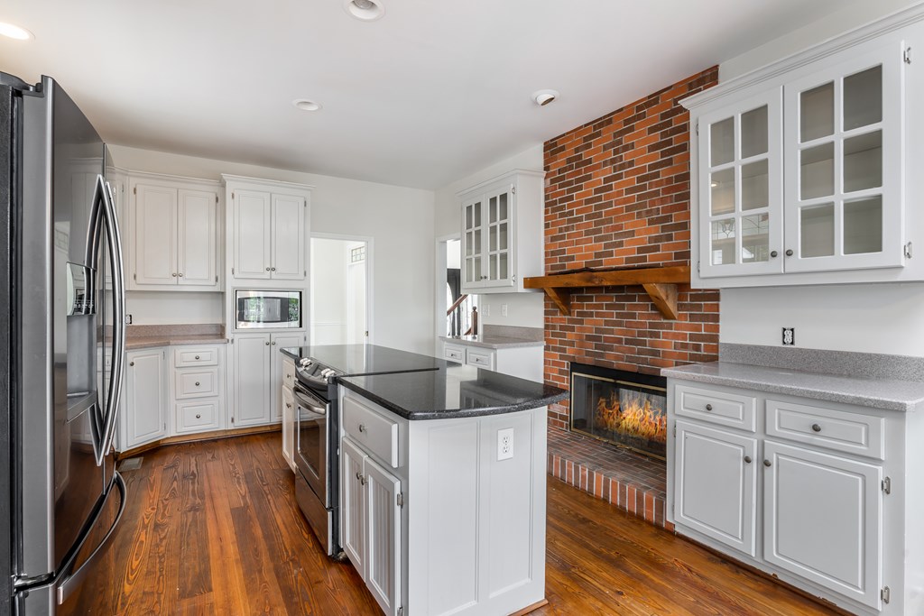 1265 Hunters Ridge Jasper, GA 30143 - Photo 13 of 50 a kitchen with granite countertop a sink and cabinets