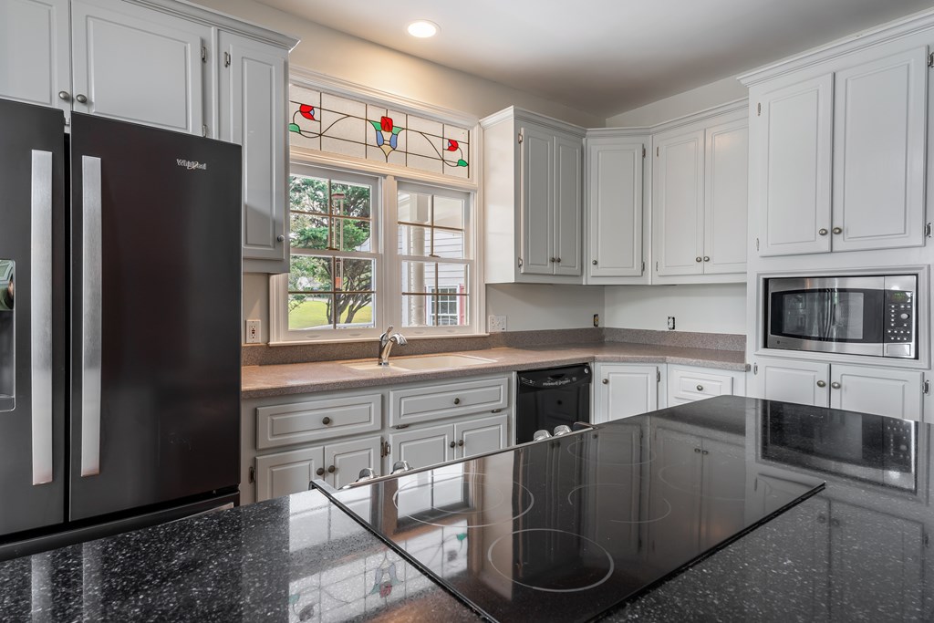 1265 Hunters Ridge Jasper, GA 30143 - Photo 15 of 50 a kitchen with stainless steel appliances granite countertop a refrigerator sink and stove