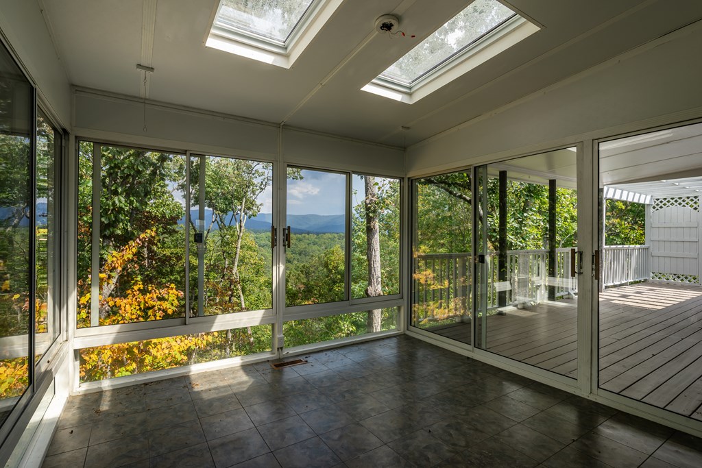 1265 Hunters Ridge Jasper, GA 30143 - Photo 18 of 50 a view of an empty room with wooden floor and a floor to ceiling window