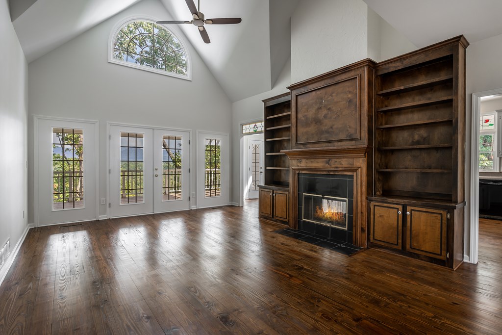 1265 Hunters Ridge Jasper, GA 30143 - Photo 7 of 50 a view of an empty room with a window and wooden floor