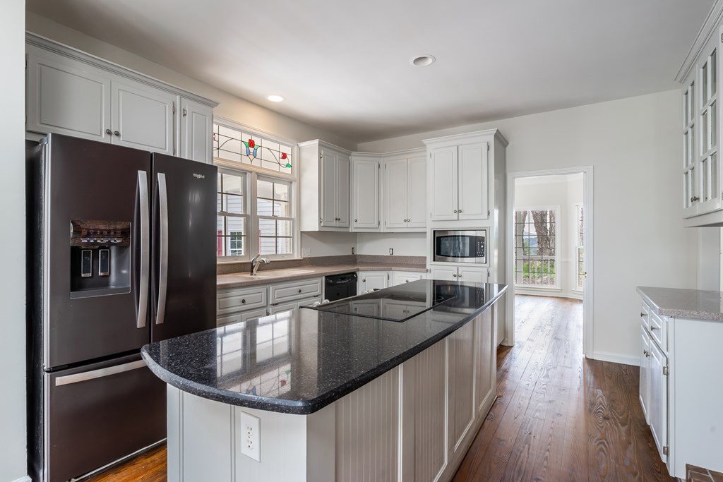 1265 Hunters Ridge Jasper, GA 30143 - Photo 10 of 50 a kitchen with stainless steel appliances granite countertop a sink a stove and refrigerator