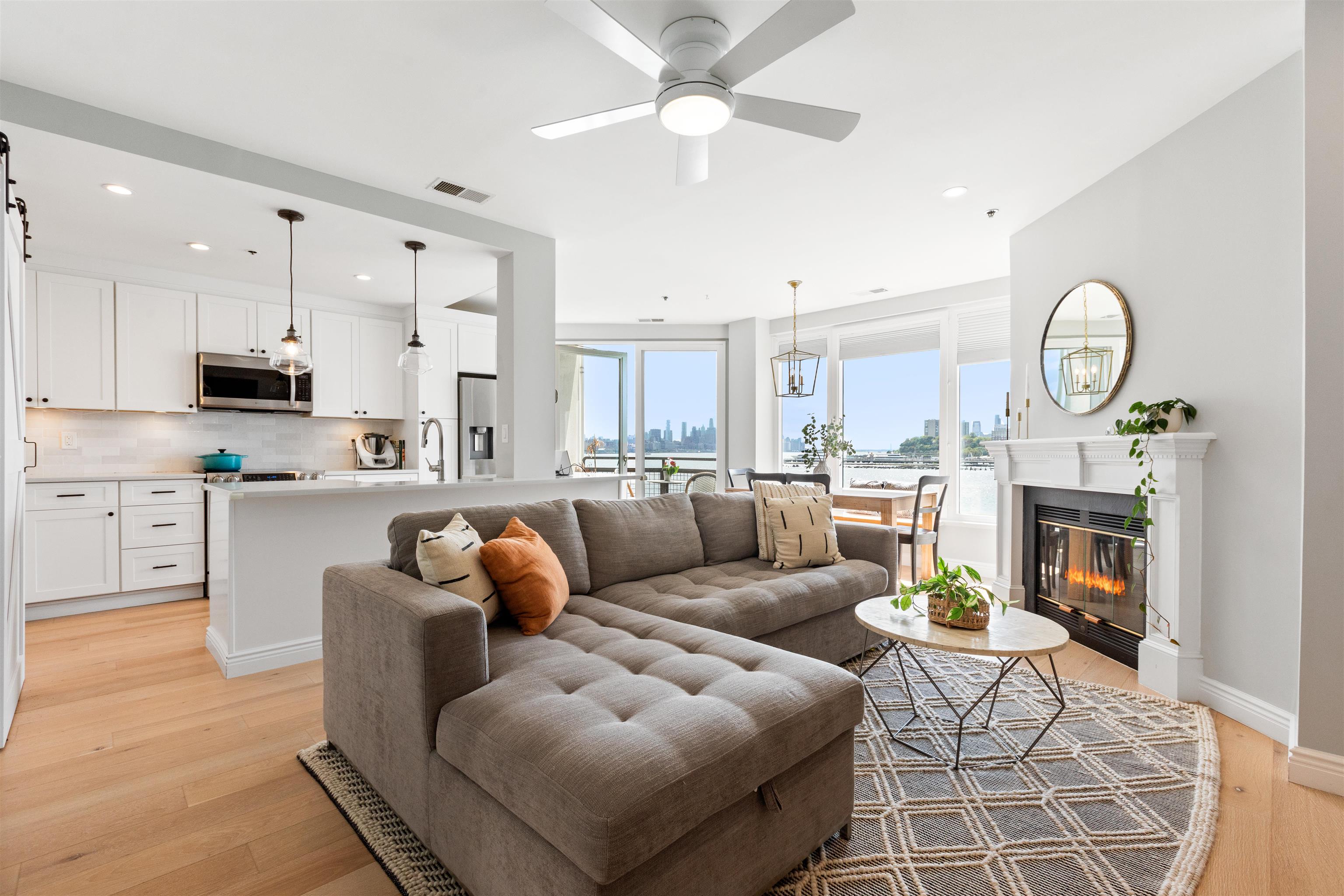 a living room with furniture kitchen view and a fireplace