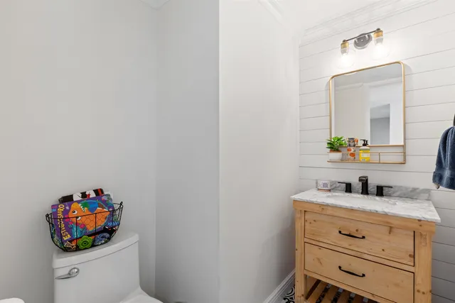 a bathroom with a sink mirror and vanity