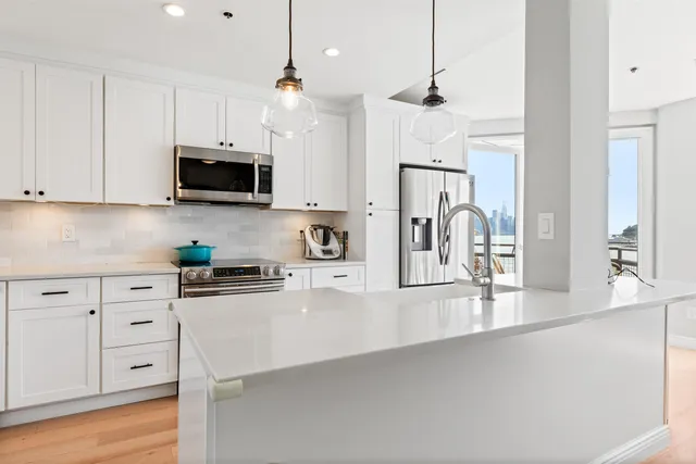 a kitchen with stainless steel appliances a stove sink microwave and cabinets