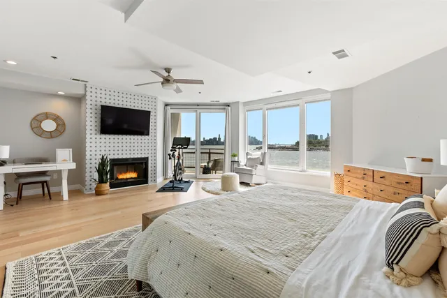 a large bedroom with a bed and a fireplace