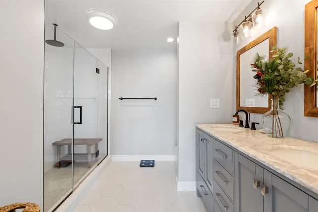 a bathroom with a granite countertop sink a toilet and a mirror