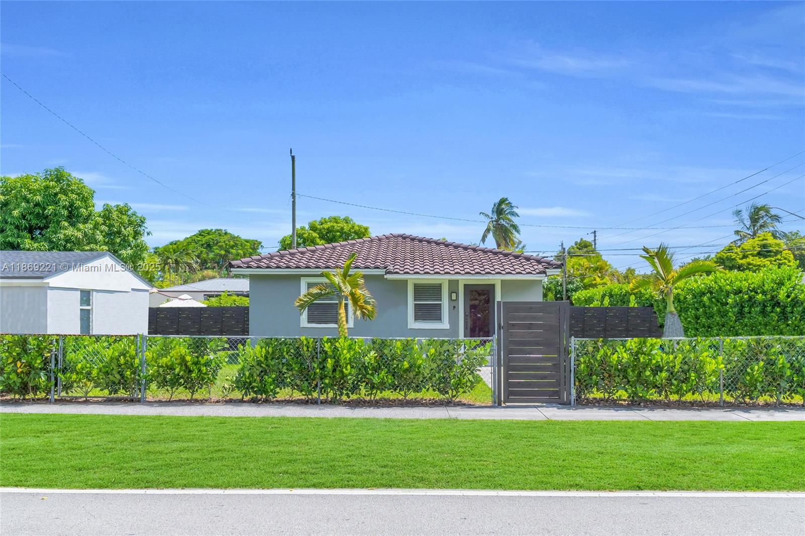 6490 Southwest 37th Street Miami, FL 33155 - Photo 1 of 23 a front view of a house with a yard