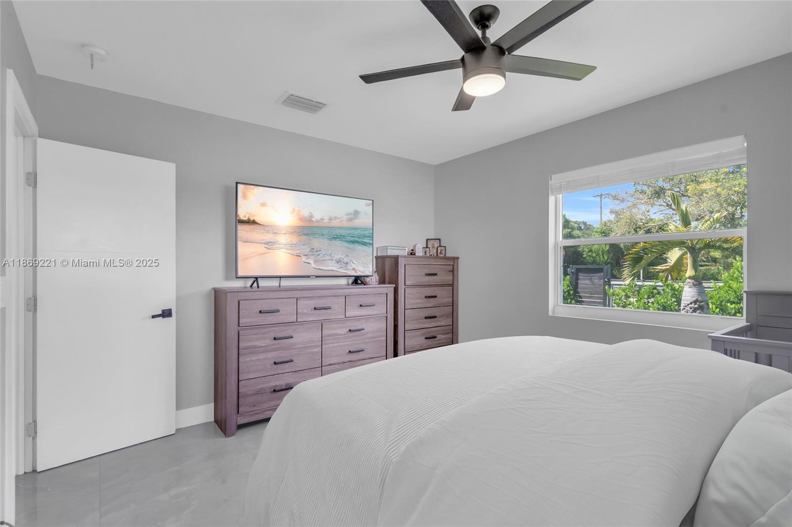 6490 Southwest 37th Street Miami, FL 33155 - Photo 13 of 23 a bedroom with a bed and a flat screen tv