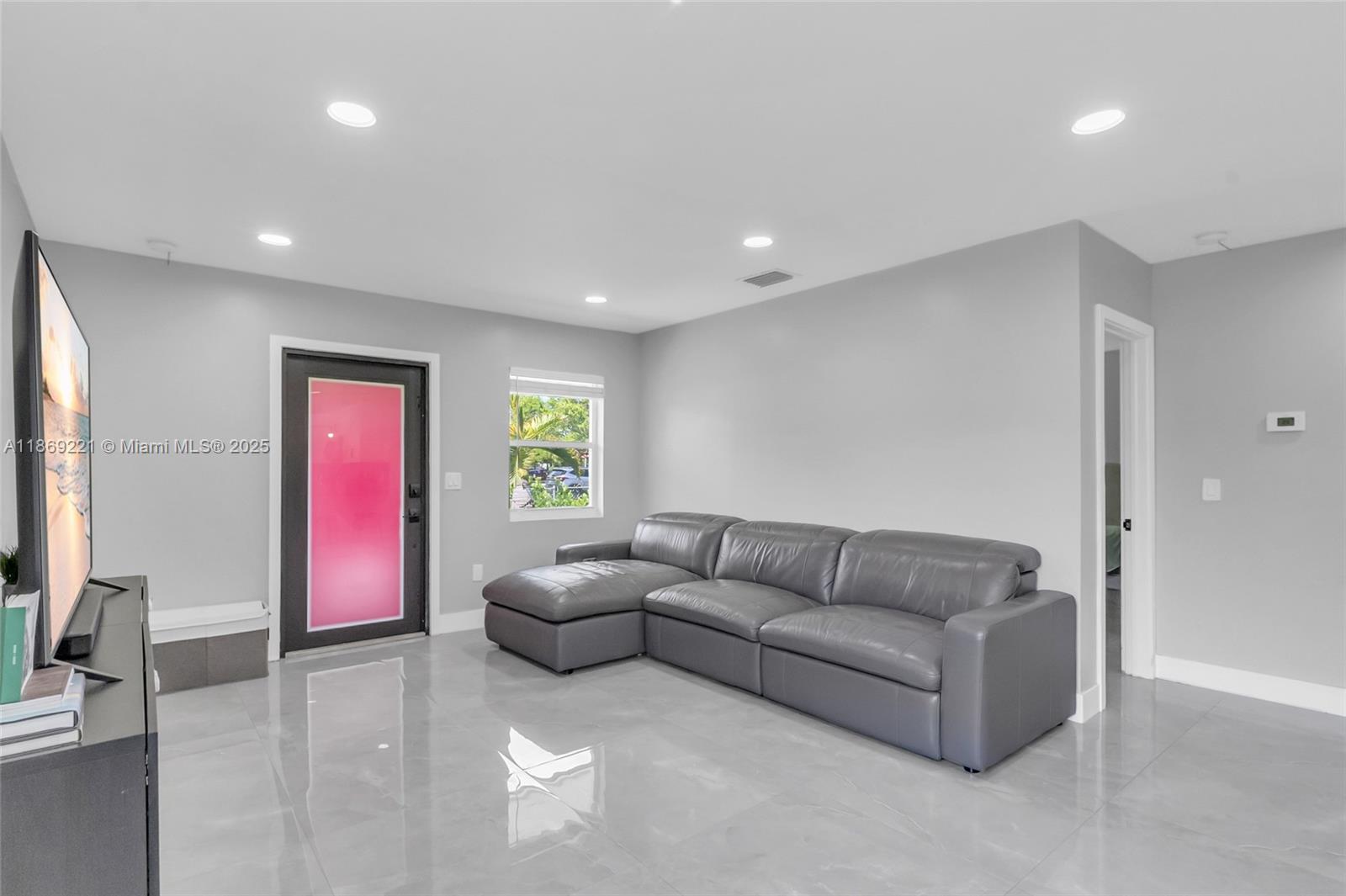 6490 Southwest 37th Street Miami, FL 33155 - Photo 5 of 23 a living room with furniture and a flat screen tv