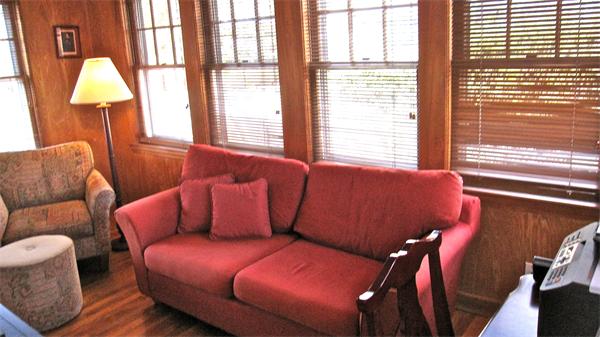 9 Glendale Road Marblehead, MA 01945 - Photo 10 of 13 a blue couch sitting in a living room next to a window