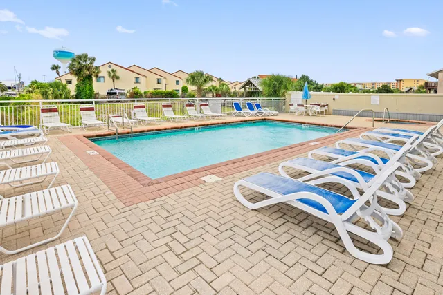 a view of a hallway with wooden floor and a bathroom