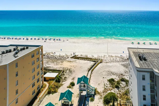 a view of a dining room with furniture and a chandelier