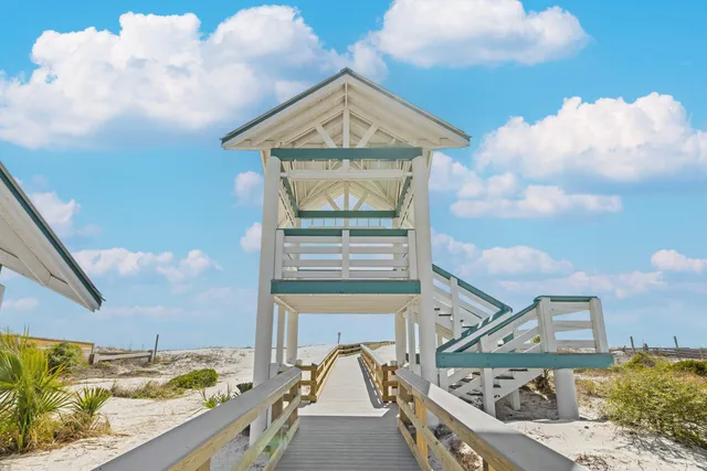a living room with furniture a chandelier and a floor to ceiling window