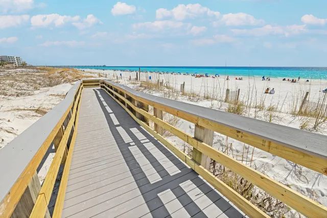 a living room with furniture a ceiling fan and a window
