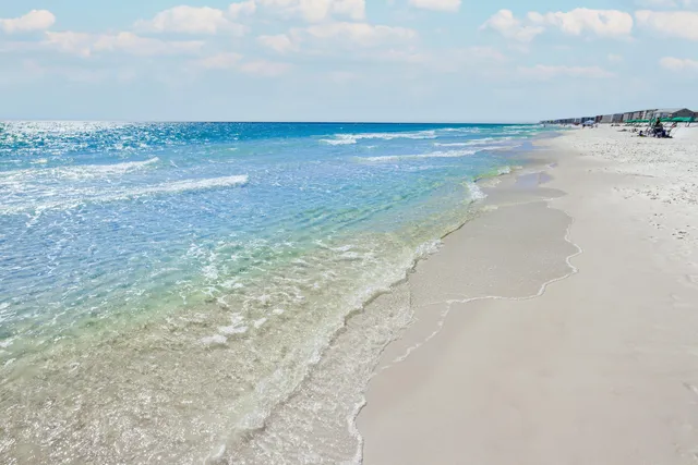 a living room with furniture a floor to ceiling window and a flat screen tv