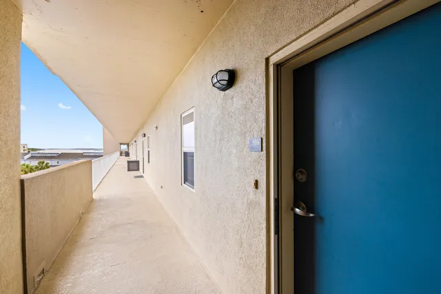 a view of a balcony with furniture and a floor to ceiling window