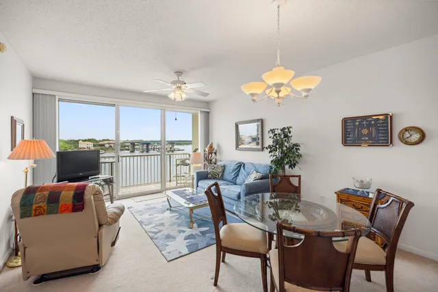 a view of a dining room with furniture and a chandelier