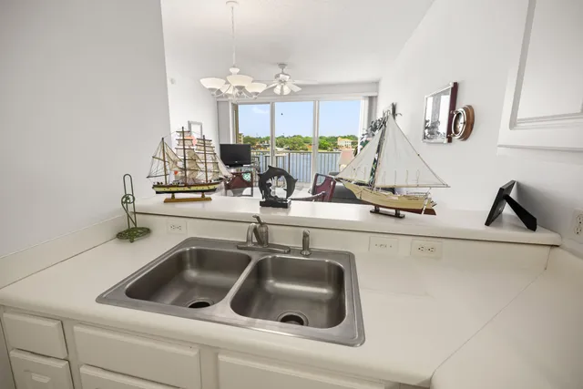a bedroom with two beds and a chandelier