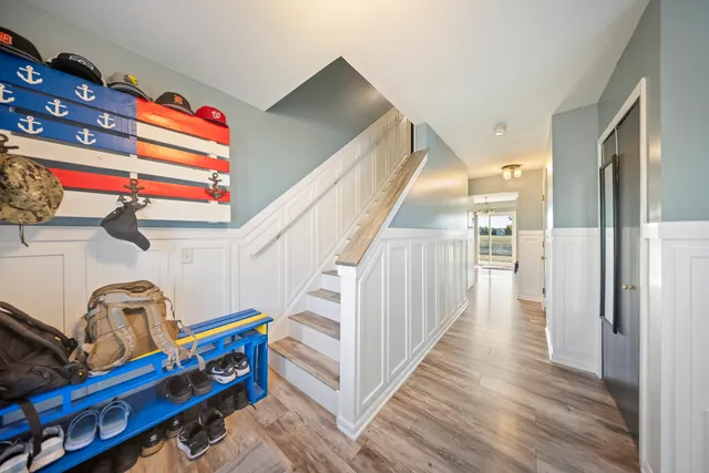 a view of hallway with stairs and wooden floor