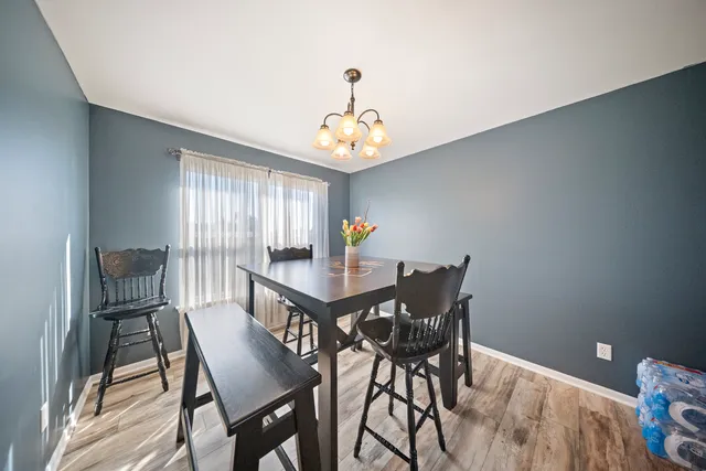 a view of a dining room with furniture and window