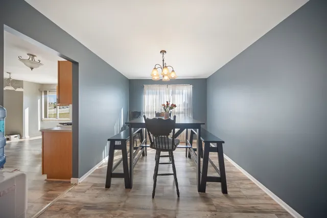 a view of a dining room with furniture and window