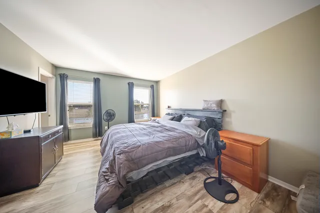 a bedroom with a bed and a flat screen tv