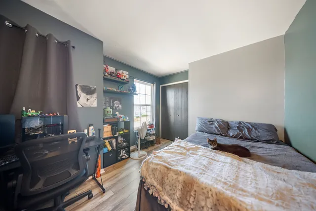 a bedroom with a bed window and table