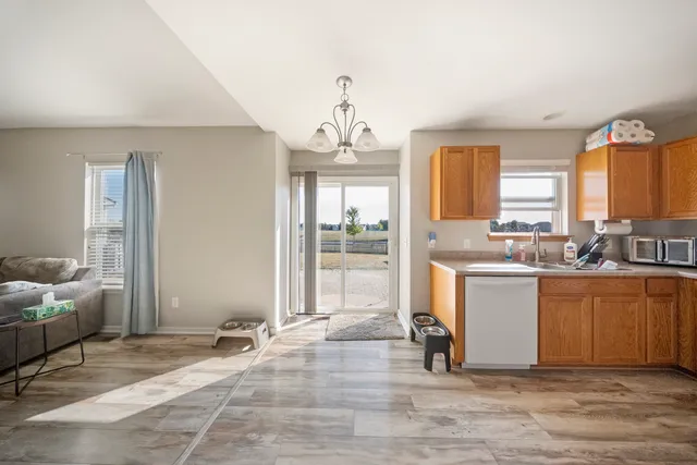 a living room with granite countertop furniture and a chandelier