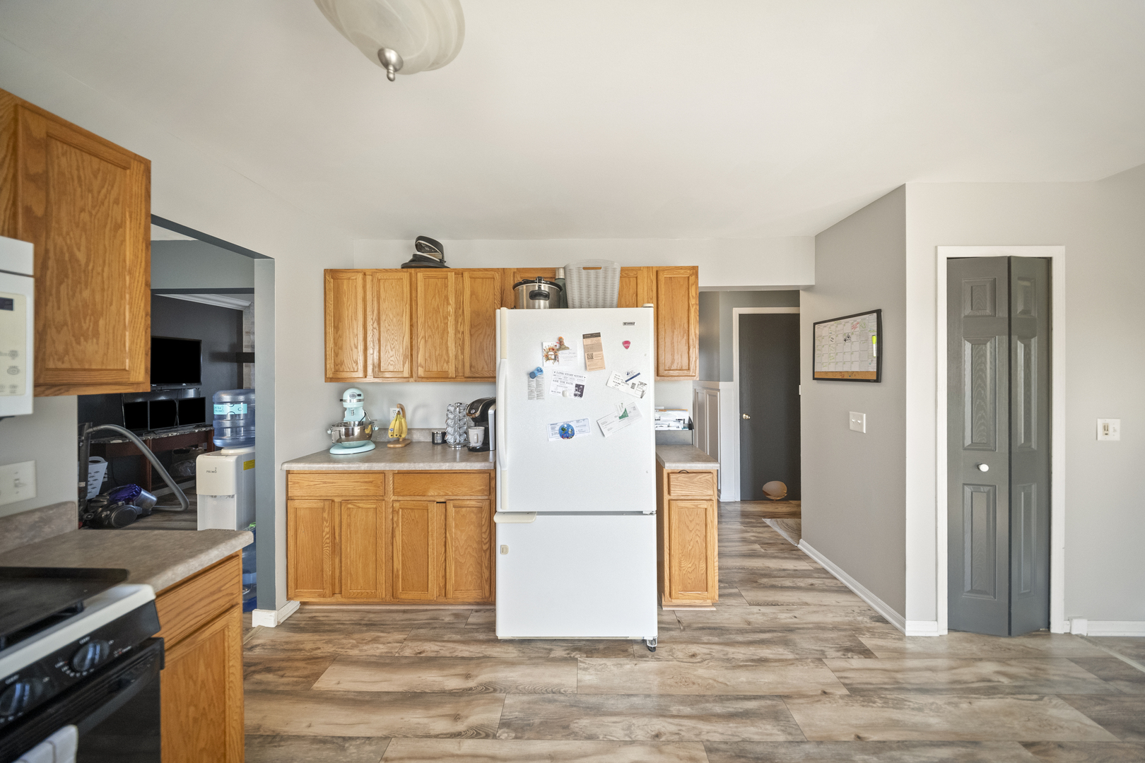 1016 Misty Landing Court Malta, IL 60150 - Photo 7 of 30 a white kitchen with a refrigerator a stove top oven a sink and dishwasher